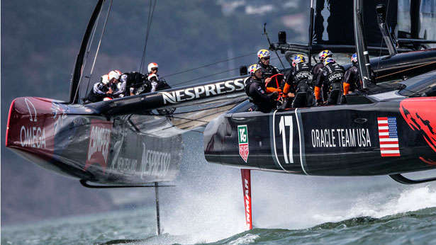 Oracle Team USA skipper, Jimmy Spithill guides there AC 72 through the water with Emirates New Zealand skipper Dean Barker bearing down on him.